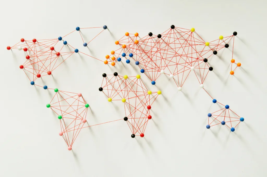 Map of the world with pins and string connecting countries representing translation