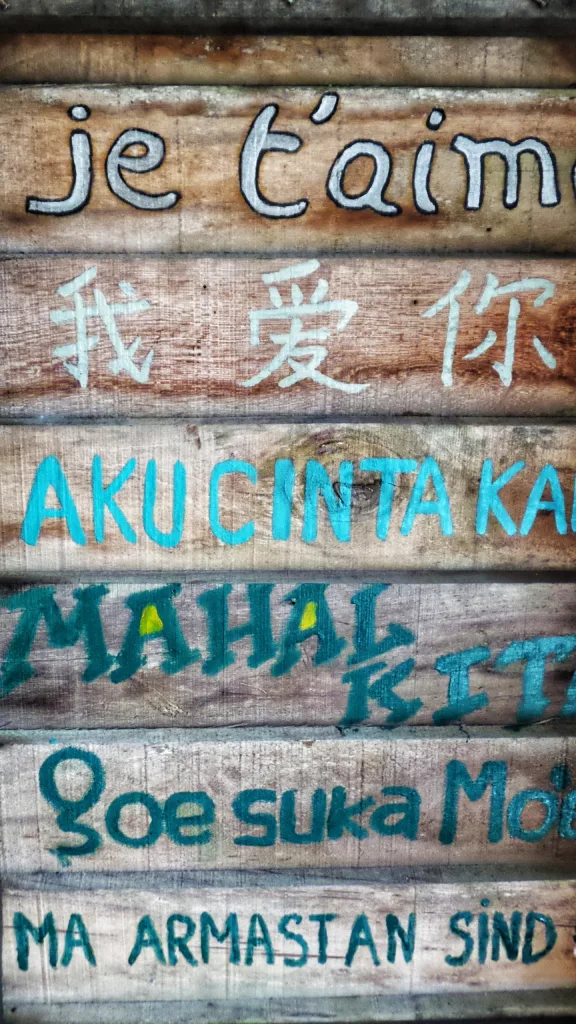 Slats of wood with words in multiple languages painted on to depict translation